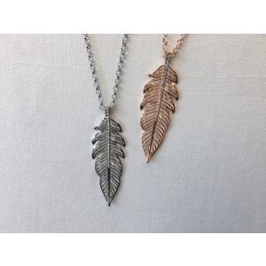 Necklace with large rhinestone-studded feather charm,...